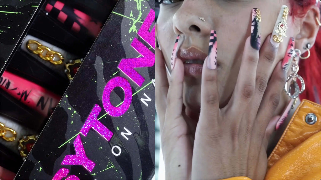 A woman wearing PSYTONE press-on nails touches her face.
